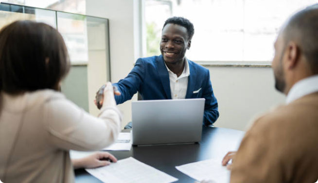 couple shaking hands with sales representative