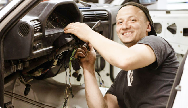 mechanic working on car dashboard