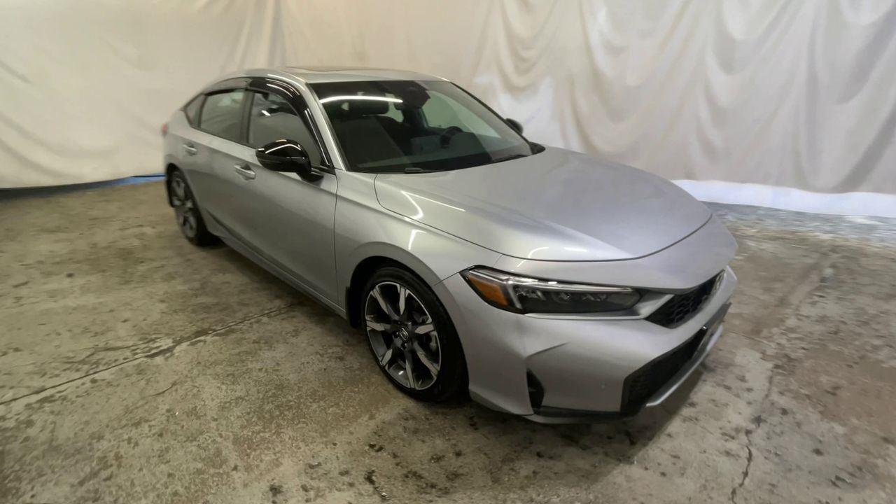 2025 Honda Civic Hatchback Hybrid Sport Touring - Solar Silver Metallic exterior view 2