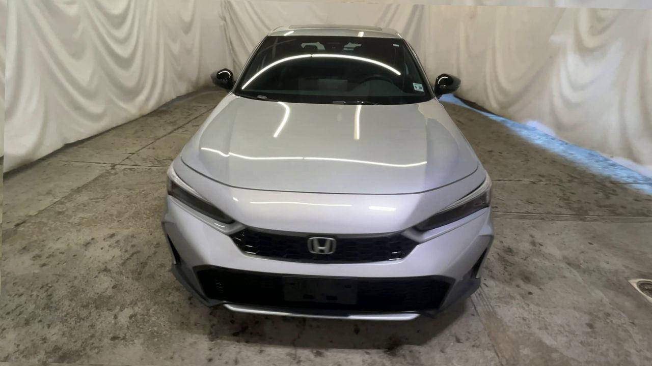 2025 Honda Civic Hatchback Hybrid Sport Touring - Solar Silver Metallic exterior view 3