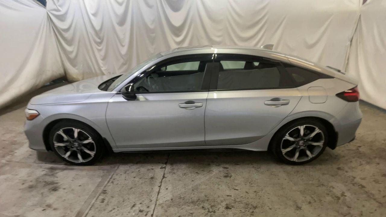 2025 Honda Civic Hatchback Hybrid Sport Touring - Solar Silver Metallic exterior view 5